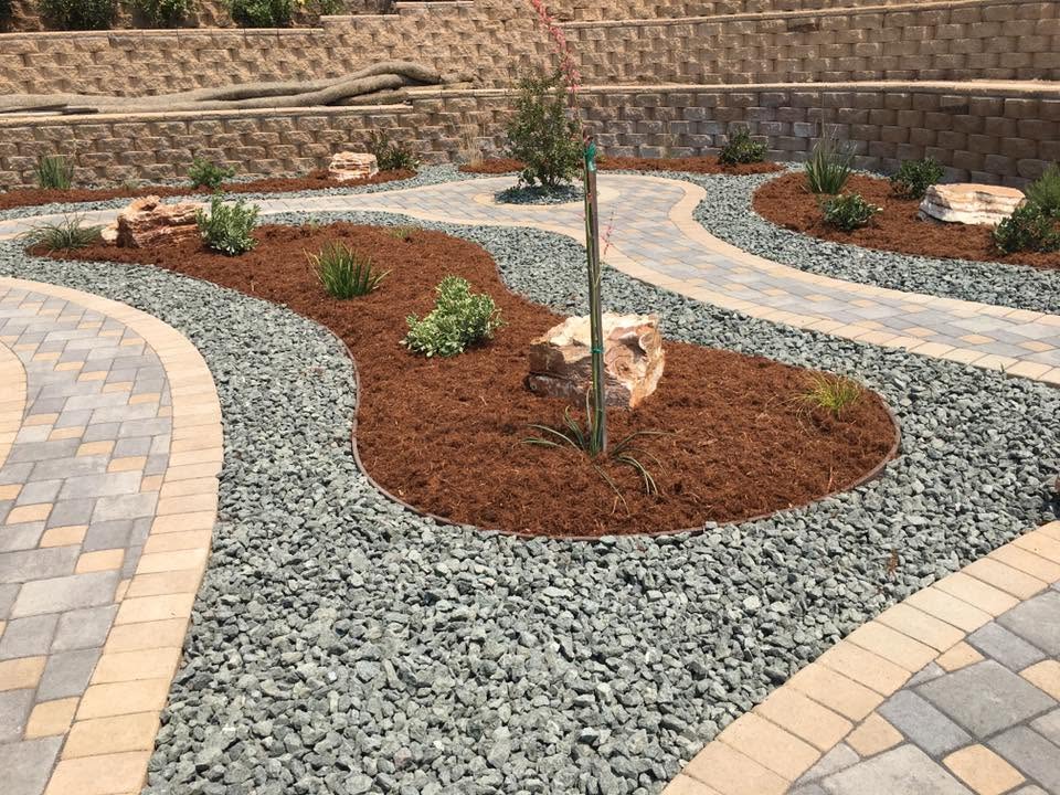 Curved paver and gravel landscape